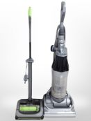A Dyson upright vacuum cleaner and a G-Tech vacuum.