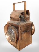 A copper-plated railway lamp with red and clear glass lenses (wired for electricity), height 36cm.