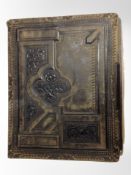 A Victorian leather-bound album of portrait photographs and postcards.