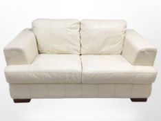 A contemporary cream leather two-seater settee, 162cm long x 95cm deep x 80cm high.