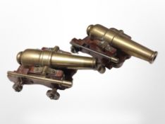 A miniature pair of brass cannons on wooden carriages, length 17cm.