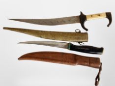An Eastern dagger in brass sheath, length 37cm, together with a further knife.