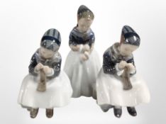 Two Royal Copenhagen figures of girls doing embroidery, and a further figure of a girl standing,