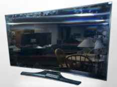 A Samsung 55-inch curved LCD TV with lead and remote.