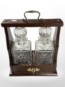 A reproduction mahogany Tantalus, height 33cm.