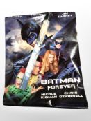 A group of rolled movie posters including Batman, etc.