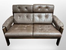 A 20th century Danish stained wood and brown buttoned leather two seater settee,