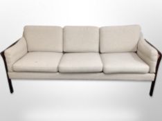 A late 20th century Danish stained beech and bergere framed three seater settee in oatmeal fabric,