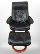 A Norwegian Ekornes black stitched leather swivel armchair with matching footstool