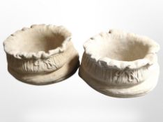 A pair of concrete sack planters,