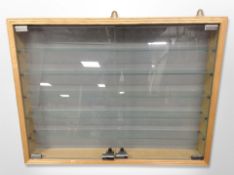 A glazed pine wall display cabinet,