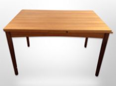 A Danish teak pull-out extending dining table,