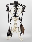 A painted wrought metal fire companion set