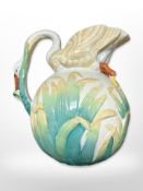 An early 20th century English pottery jug, the handle and spout in the form of a swan,