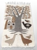 A pictorial Kilim rug depicting stylized birds beneath a tree,
