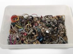 A large plastic crate of mixed costume jewellery