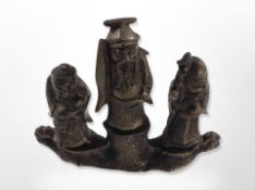 A set of three Chinese cast bronze figures of elders on stand, height 10.
