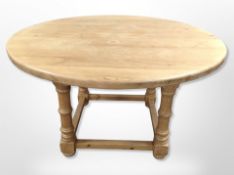 A pine circular dining table,
