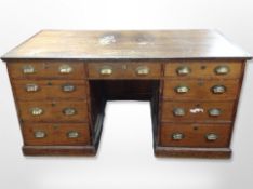 A Victorian pine twin pedestal desk fitted nine drawers,
