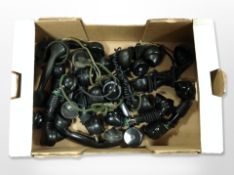 A box of vintage Bakelite telephone receivers