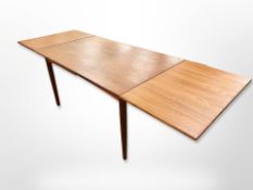 A 20th century Danish teak pull out dining table,