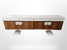 A 1970's Italian laminate low sideboard on pedestal base