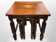 A reproduction mahogany nest of three tables,