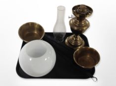 A brass oil lamp with opaque glass shade and chimney together with two brass long handled pans