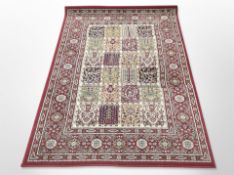 A machine made rug of Persian design,