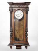 A walnut Vienna wall clock with pendulum and weights