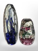 A Murano glass paperweight with flower inclusion, together with one other, tallest 14.5cm.