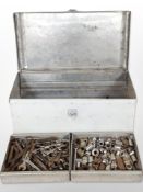 A painted metal tool chest containing spanners, sockets, etc.