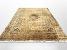 A machine made carpet of Persian design,