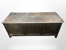 An 18th-century panelled oak coffer, 155cm wide x 59cm deep x 63cm high.