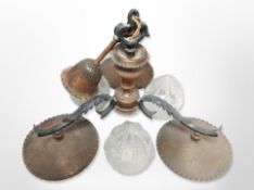 An early 20th-century hammered metal copper-effect chandelier, with pressed frosted glass shades,