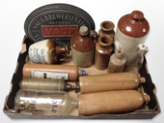 A group of glass and stoneware bottles, some bearing advertising, Vaux Breweries Ltd sign, etc.