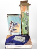 A boxed Duplo portable double burner stove, a further camping stove, and a camping bed.