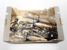 Three contemporary wood and wrought-metal candle holders with glass bowls and wall brackets.