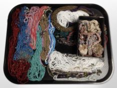 A tray and further small box containing an assortment of coloured bead necklaces.