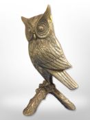 A cast-brass figure of an owl perched on a branch, height 36cm.
