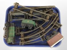 A tin plate diecast metal locomotive, two carriages, and a quantity of track.