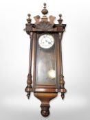 A continental walnut Vienna wall clock with enamelled dial.