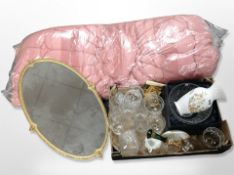 A vintage eiderdown together with a gilt-framed mirror and a box containing crystal glasses and