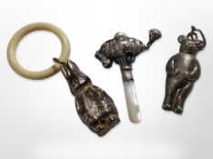 A silver and mother of pearl baby's rattle plus two other plated examples.