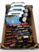 A group of Thomas the Tank Engine locomotives and carriages, in plastic boxes.