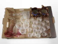 A group of crystal drinking glasses, pair of cranberry glass tulip vases, two copper lustre jugs,