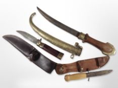 An Arabic Jambiya knife in ornate brass sheath,