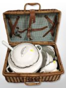 A vintage wicker picnic hamper containing a Ralph Lauren porcelain lidded tureen and several bowls.