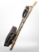A shooting stick, two walking sticks, one bearing enamelled badges,