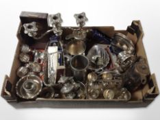 A group of silver-plated wares including cutlery, goblets, woven basket, table candelabrum,